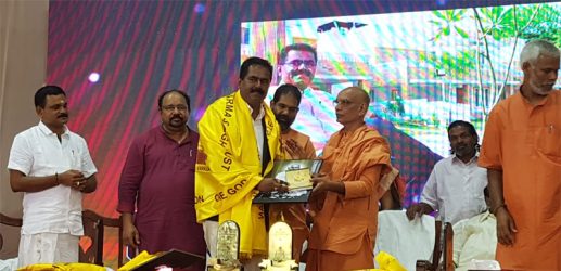 Sunil Kumar V, Managing Director, Asset Homes, receives Guru Ratna Award from Swami Vishudhananda.